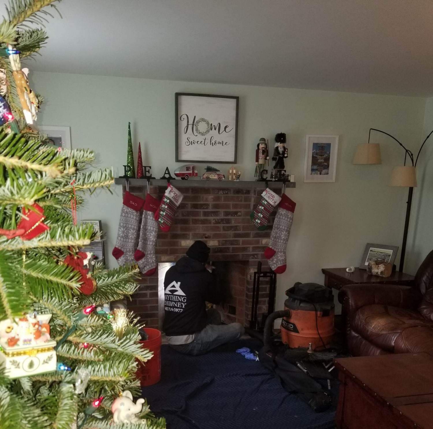 Robert, a technician at Anything Chimney, LLC, performing a chimney cleaning from the bottom of the chimney using the power sweeping method.